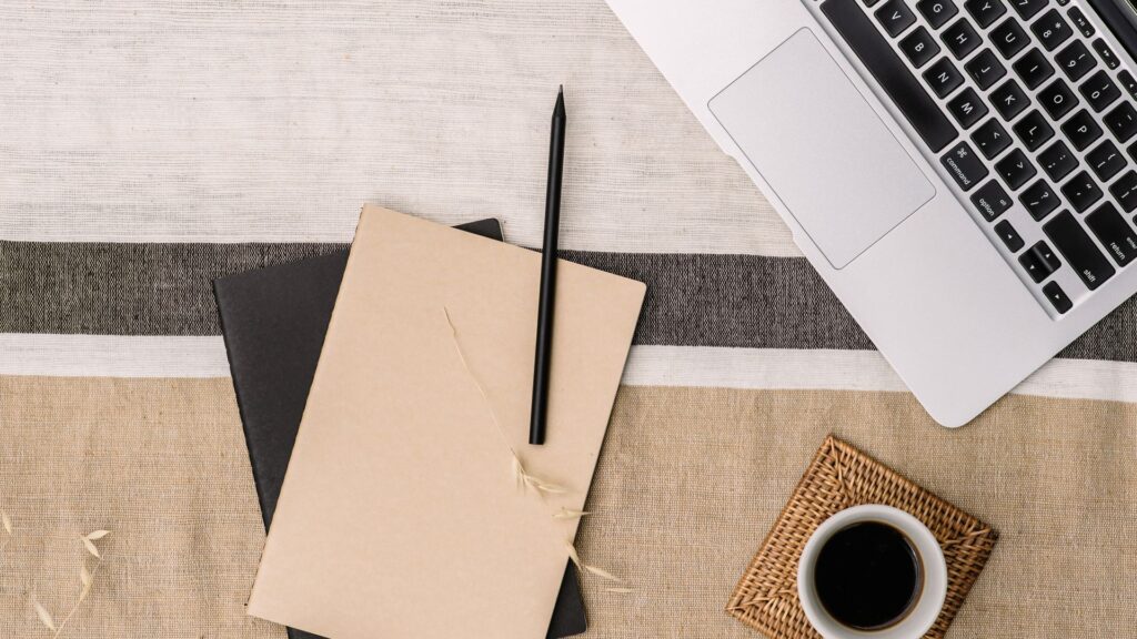 laptop and writing supplies