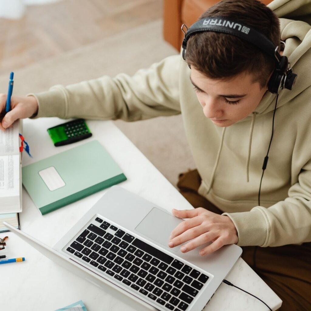 Student with book and laptop 