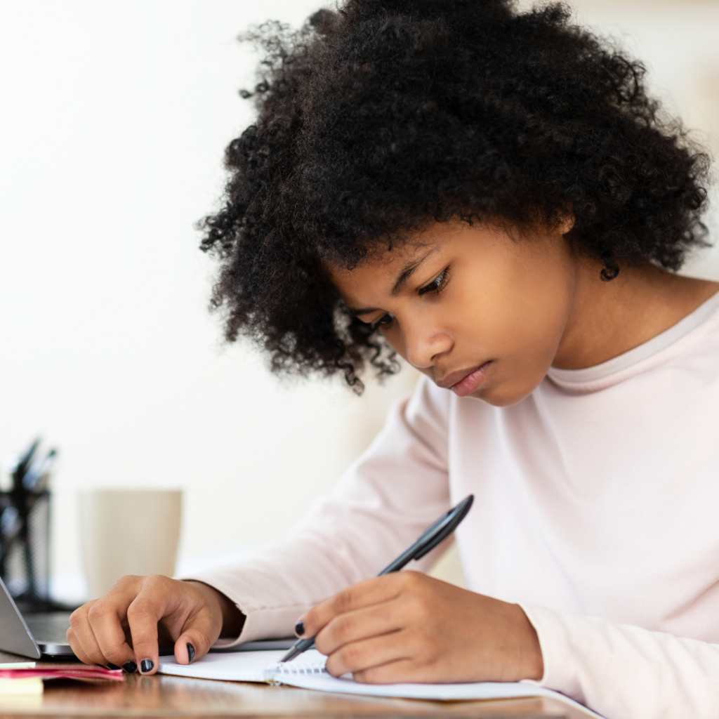 Four Tips for Success With EIW's Homeschool Writing Curriculum 3 a child writing with pen in a notebook